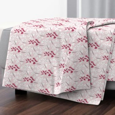 Throw blanket with abstract roses in pink