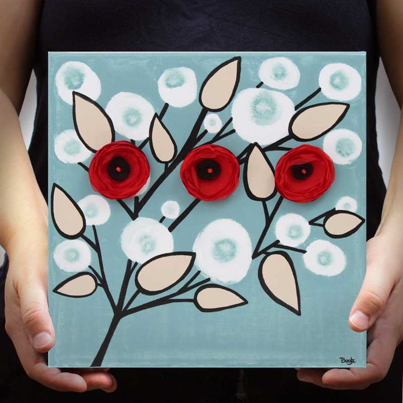 Held wall art of red and black flower branches