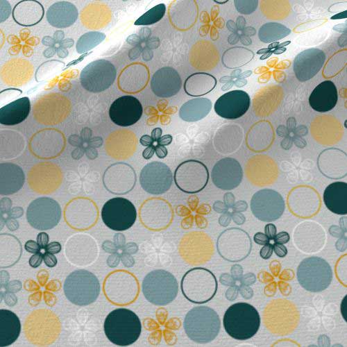 Polka dot print on fabric in yellow, blue, gray