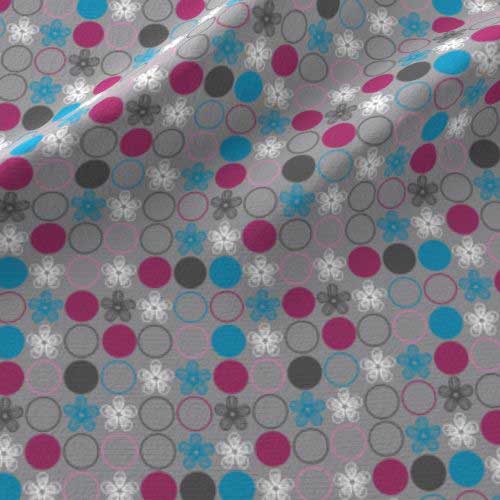 Polka dot print on fabric in pink, blue, gray
