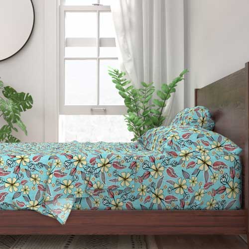 Large floral print on aqua bed sheets