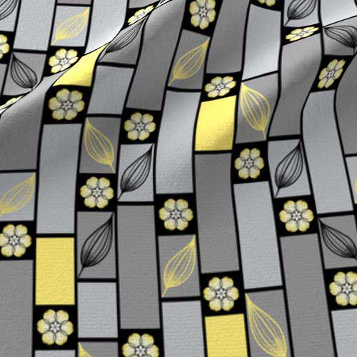 Fabric print of bricks and flower in gray, black, and yellow