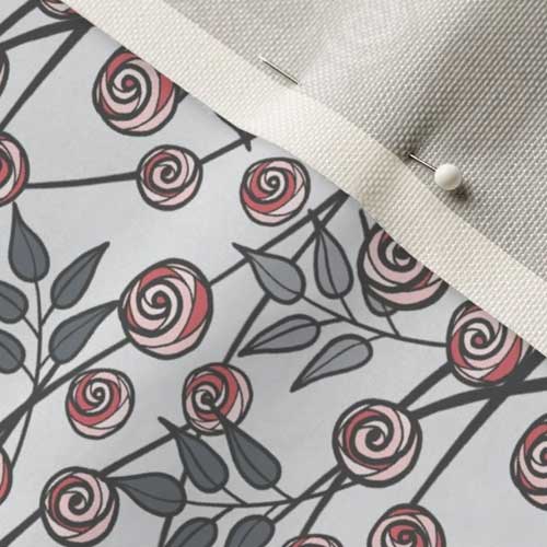 Pinned fabric swatch of pink rose branches on gray