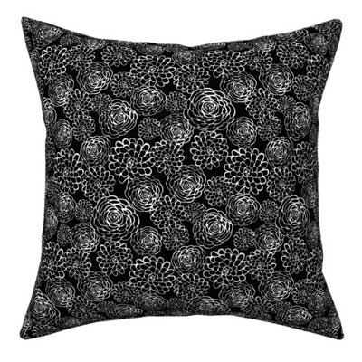 Pillow with white rose pattern on black fabric