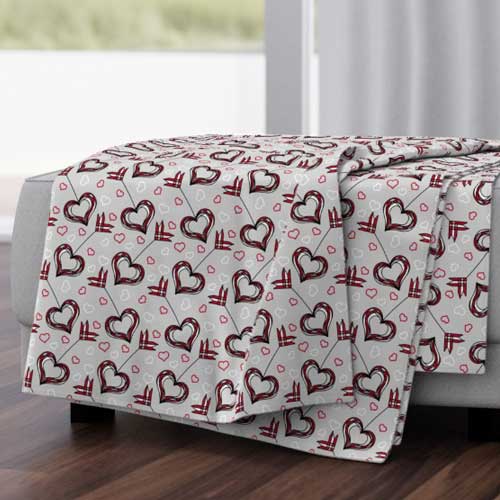 Throw blanket with cupid's arrows for Valentines day in red and gray