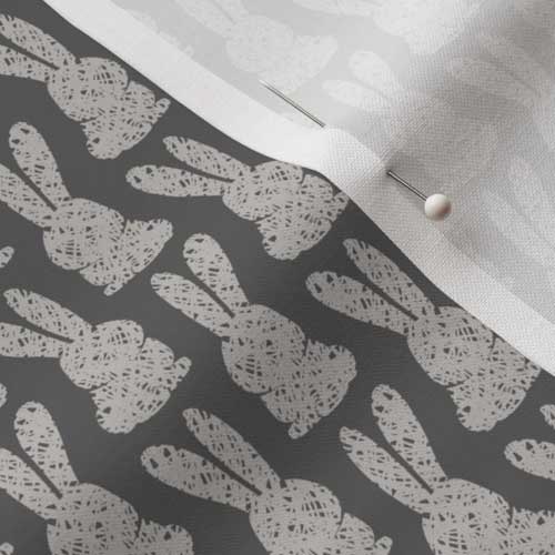 Close up of fabric with bunny print in gray charcoal