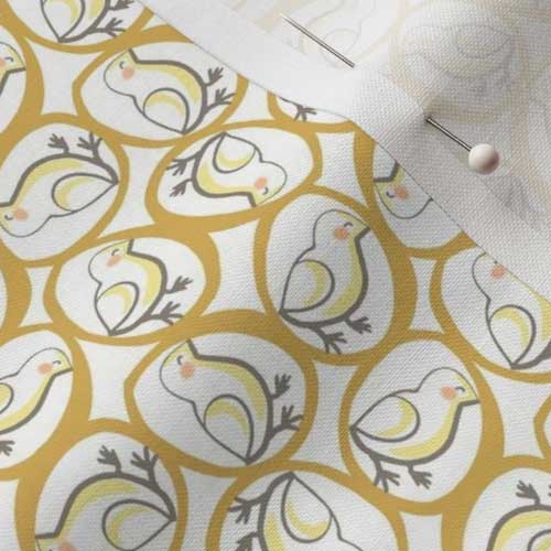 Close up of fabric with yellow chicks and yellow eggs