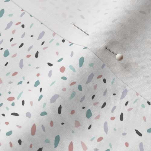 Close up of fabric with egg speckled terrazzo on white