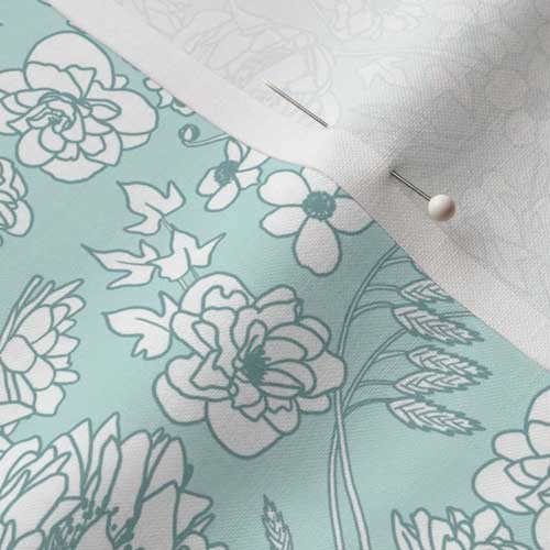 Close up of fabric with country floral in soft teal and white