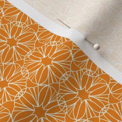 Pinned fabric with orange and white mandalas