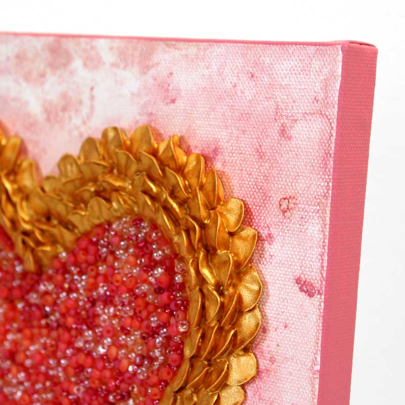 Angled view of art of pink and gold sculpted heart