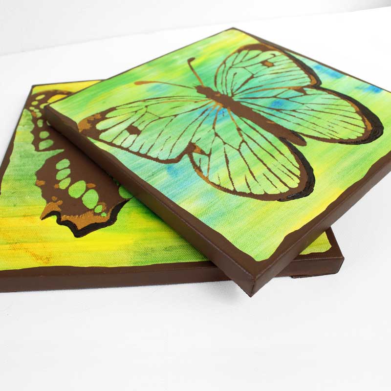 Stack of art with butterflies in green and yellow