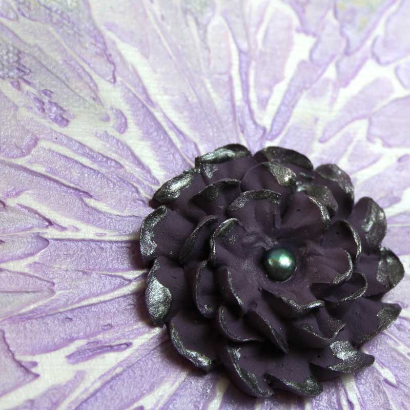 Close up of mini art of purple zinnia