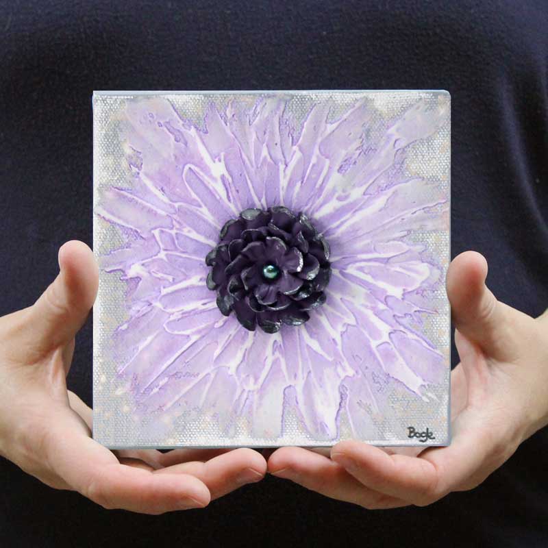 Held in hand mini art of purple zinnia