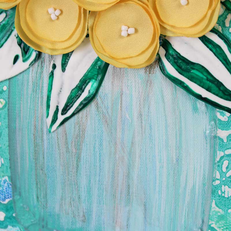 Close up of vase on yellow and teal floral still life