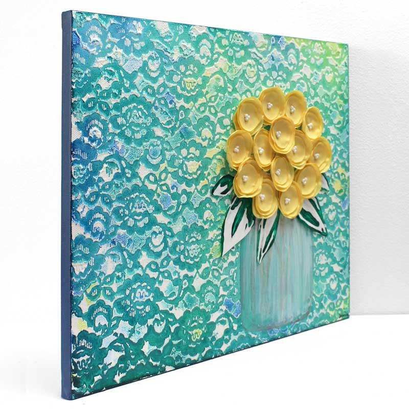 Side view of yellow and teal floral still life