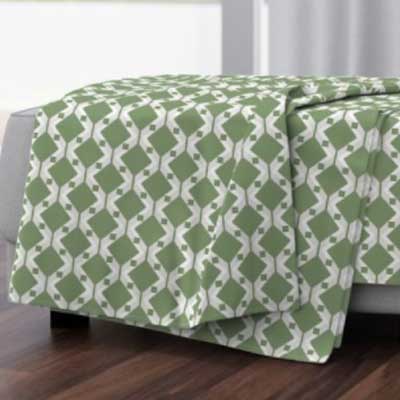 Throw blanket with green geometric pattern
