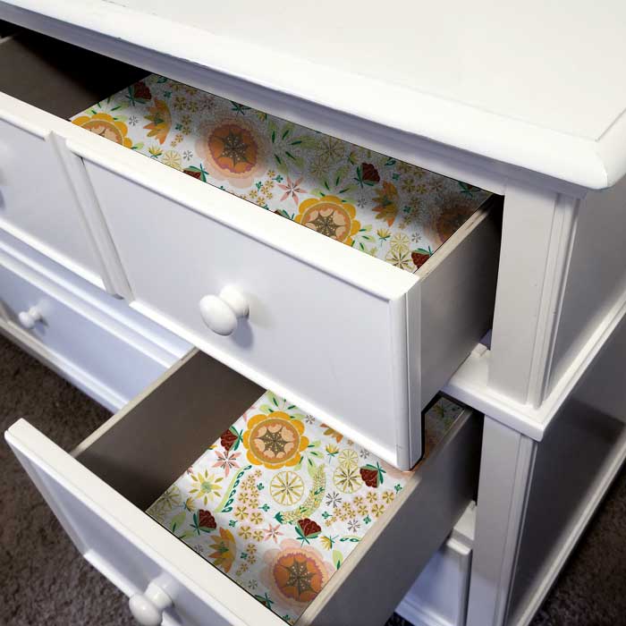 Bright woodland flora print on dresser drawer liner