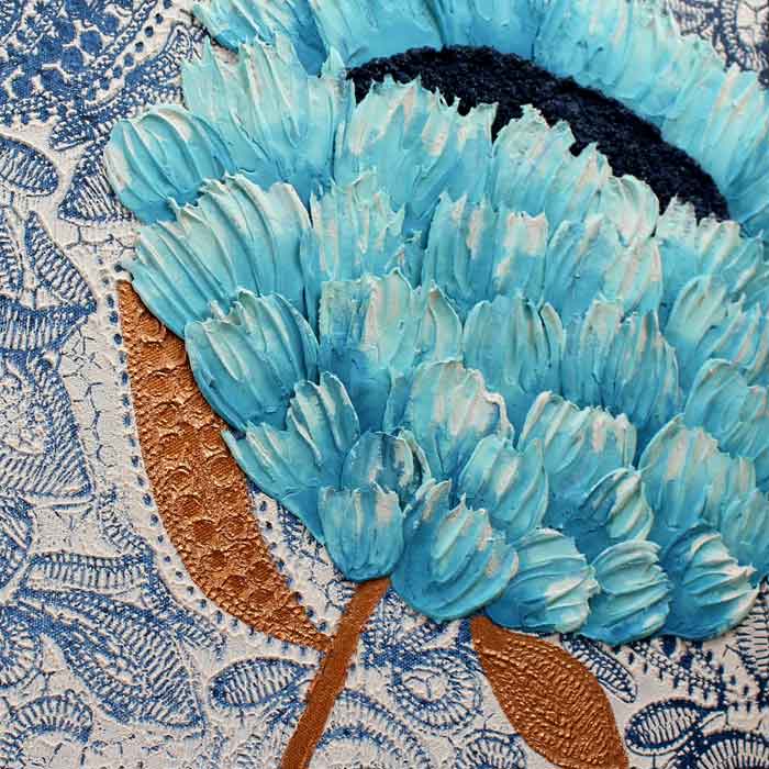 Textured petals on wall art with blue and copper feather flowers