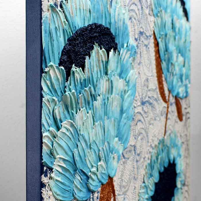 Close up of wall art with blue and copper feather flowers