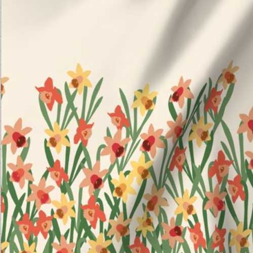 Border fabric of orange and yellow daffodils on cream