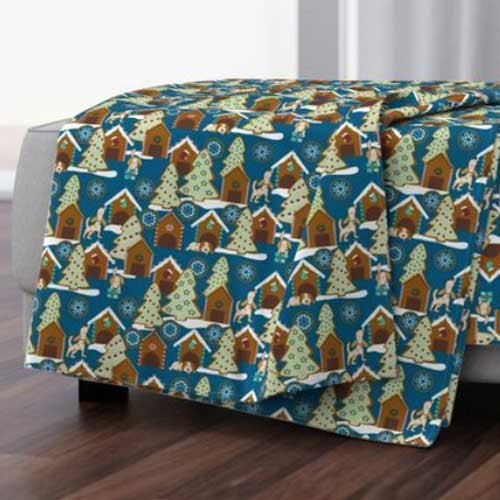 Throw blanket with gingerbread houses and dog cookies on blue
