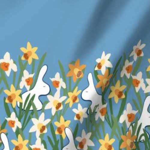 Border fabric of daffodils with white rabbits on true blue for dress hem
