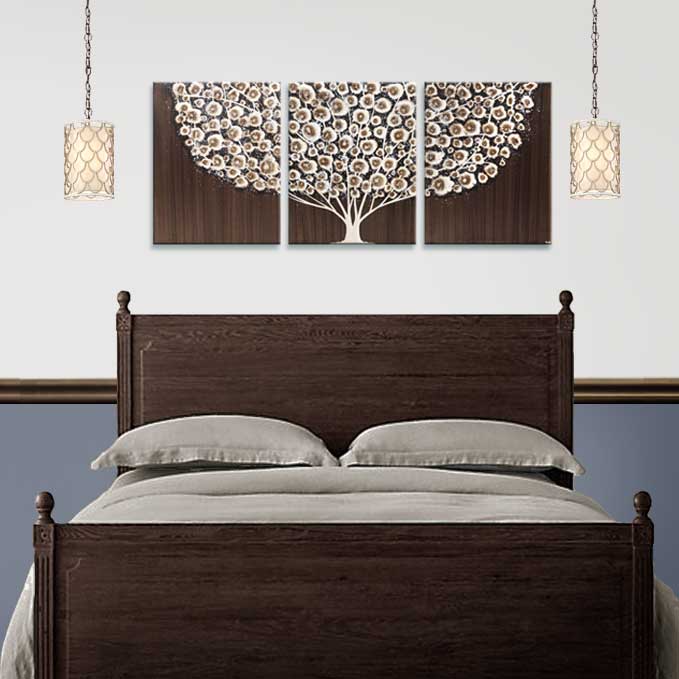 Painting of brown tree above a queen bed