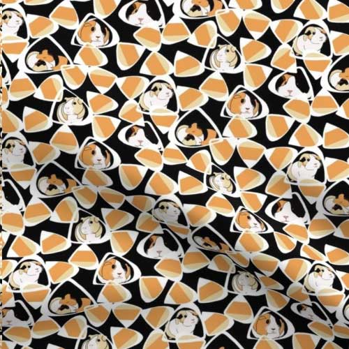 Fabric with guinea pigs camouflaged in candy corn