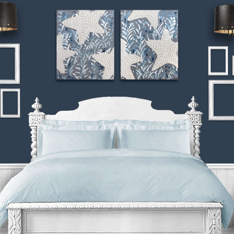 Painting of starfish hung above a twin bed