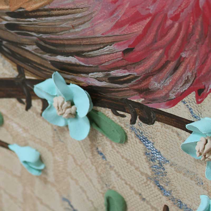 Close up of sculpted flower on painting of red finch bird on a 3d blooming branch in tan and robins egg blue