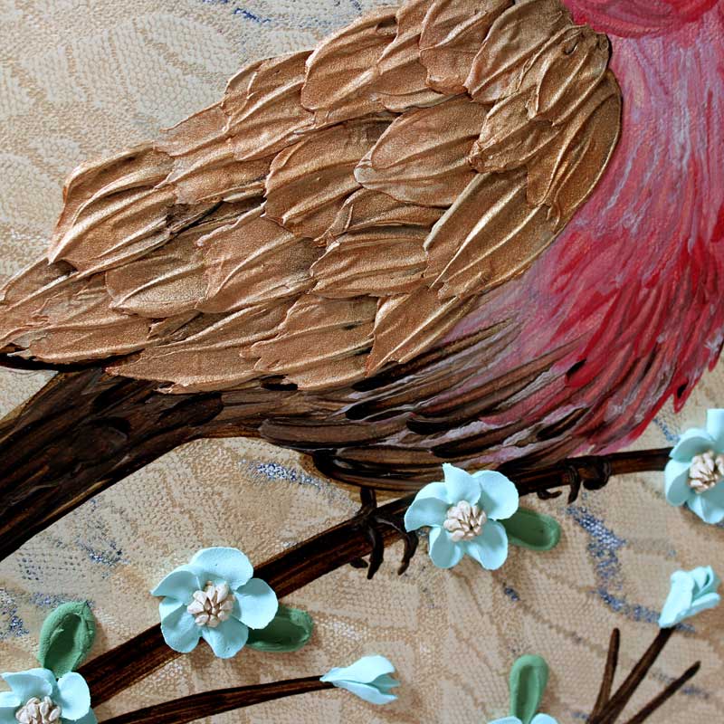 Close up of feathers on painting of red finch bird on a 3d blooming branch in tan and robins egg blue