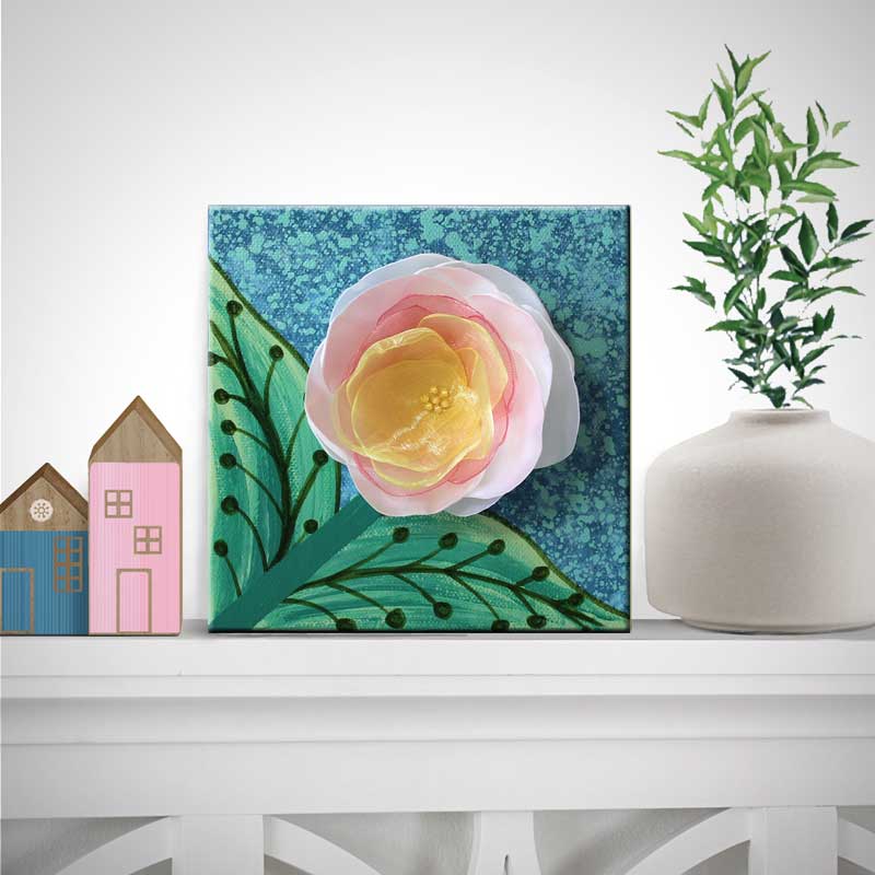 Shelf setting view of mini art painting of a flower welcoming spring
